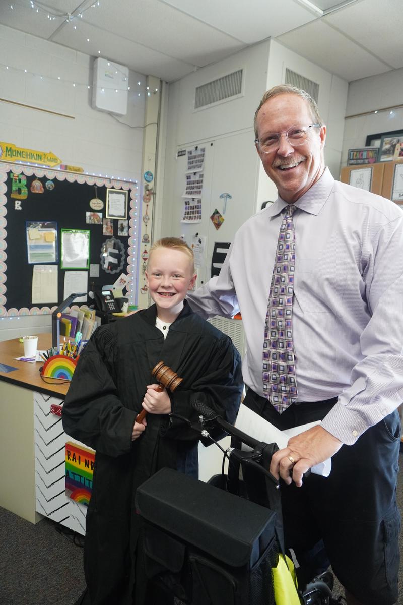 Barry County Judge Michael Schipper lets a Page 5th grader try on a judge's robe and hold the gavel.