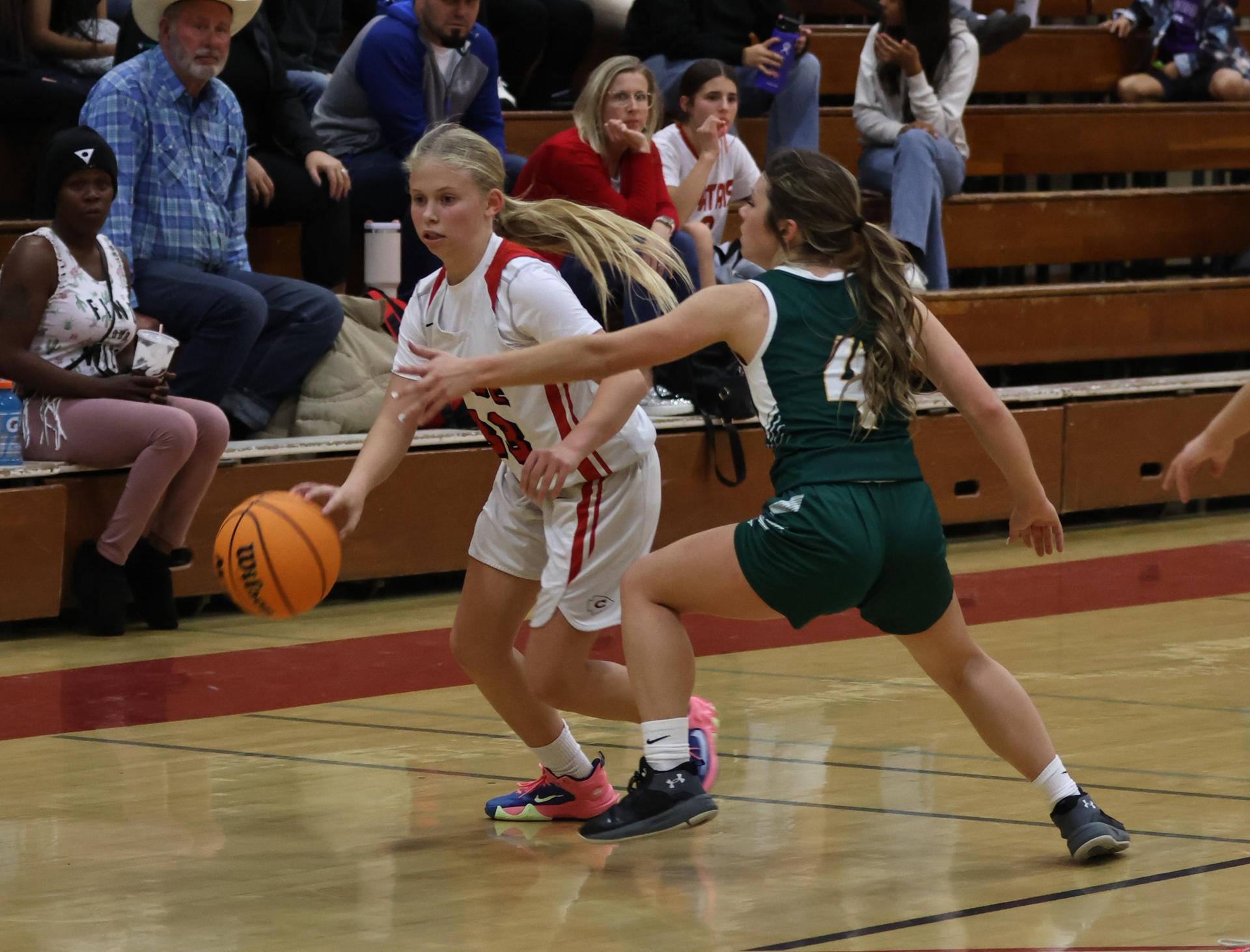 varsity girls playing basketball against mariposa
