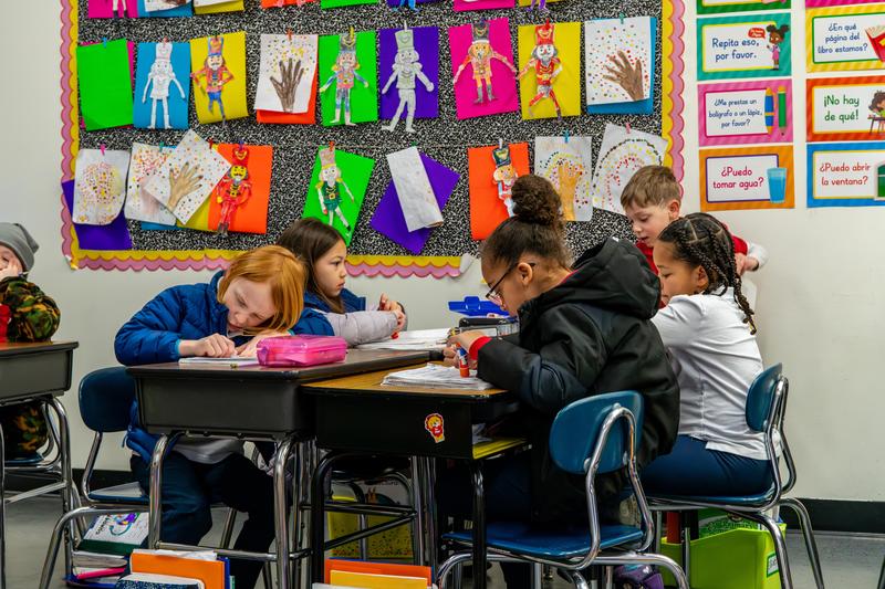 Arco Iris students work on assignments in their classroom.