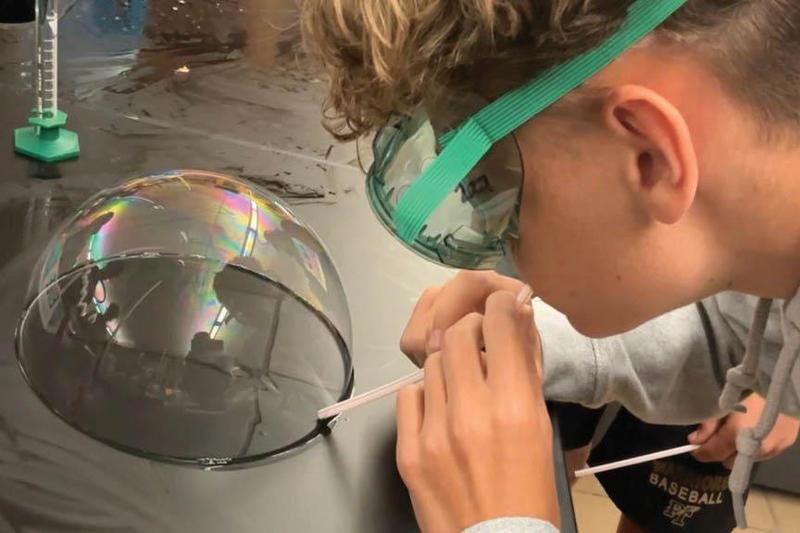 10th-grader Joseph Prosdocimo produces a bubble during Chemistry Class