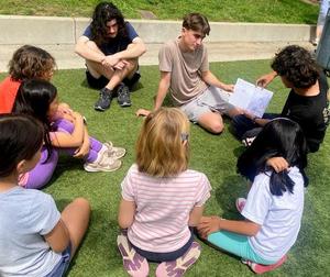 High schoolers read to second graders.