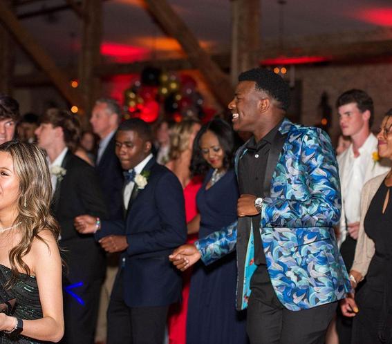 group of students in formal wear dancing