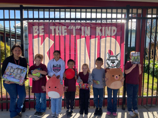 Students holding a toy