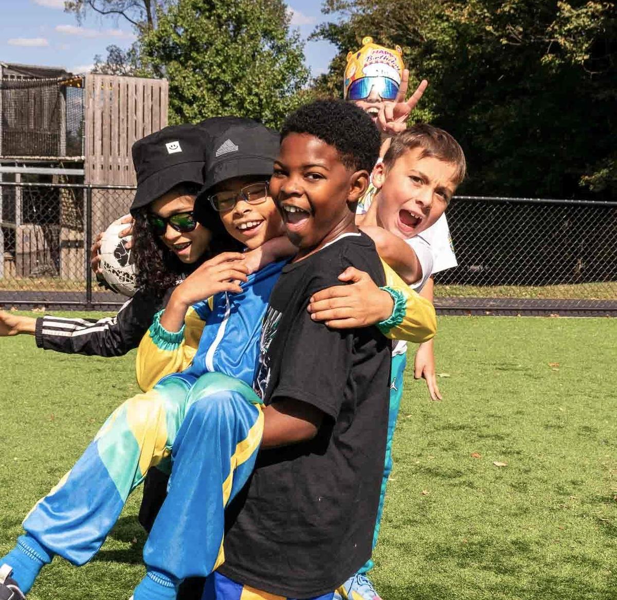 A group of Lower School students having fun on the turf field
