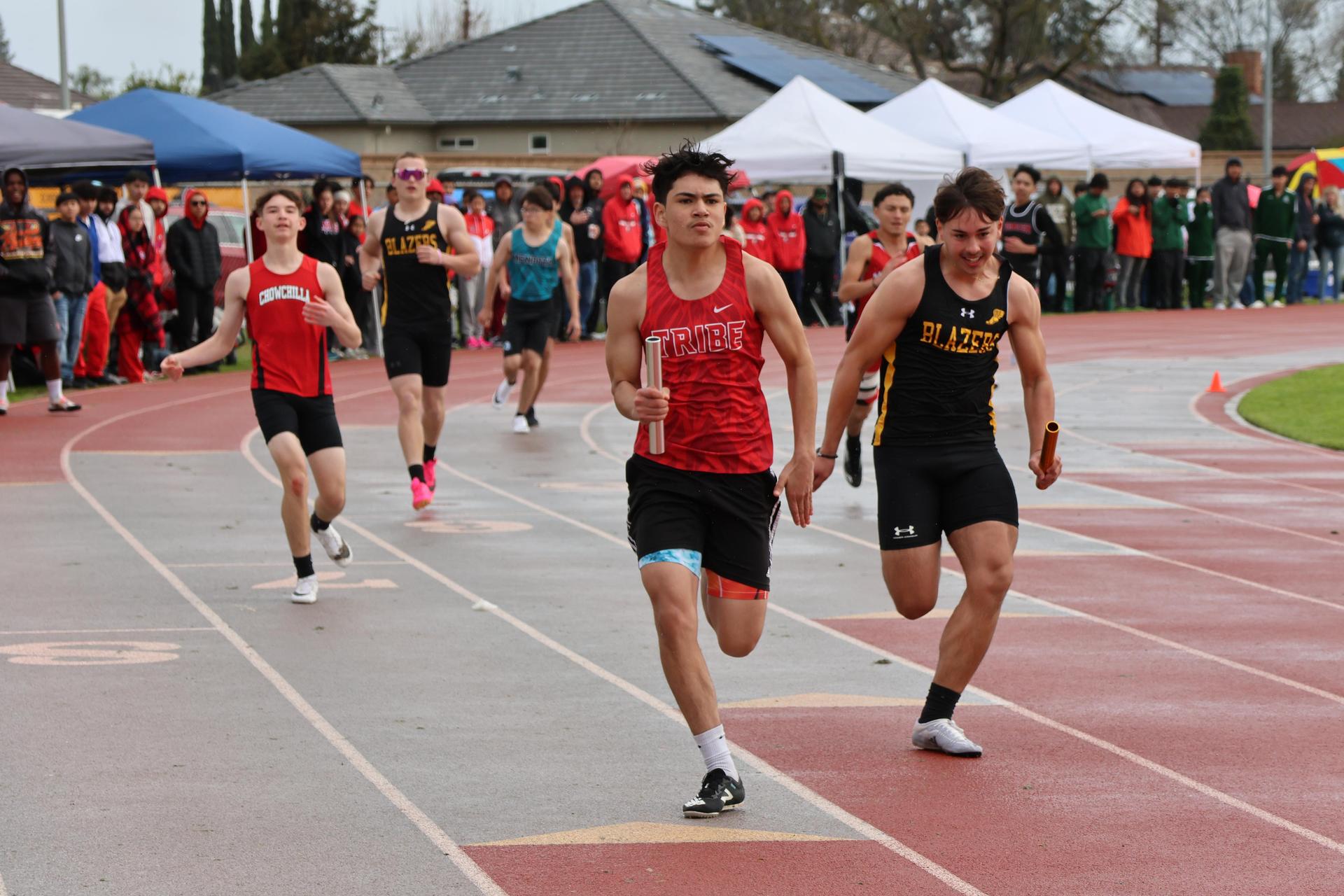 junior varsity boys running the four by 100 meter relay