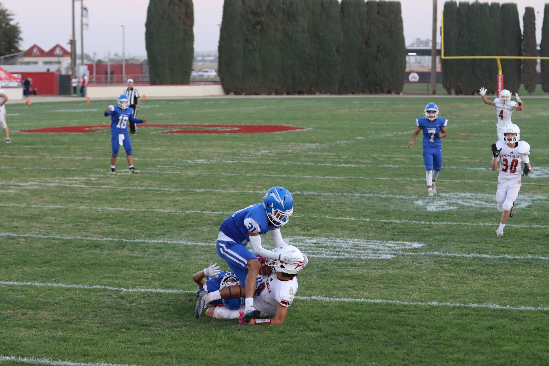 Junior Varsity football players in action against Caruthers