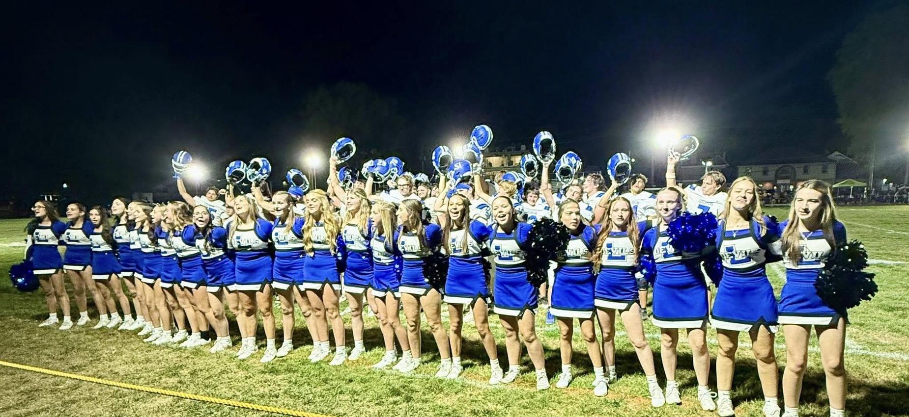 Varsity cheerleaders and Varsity football celebrating a victory over Riverview