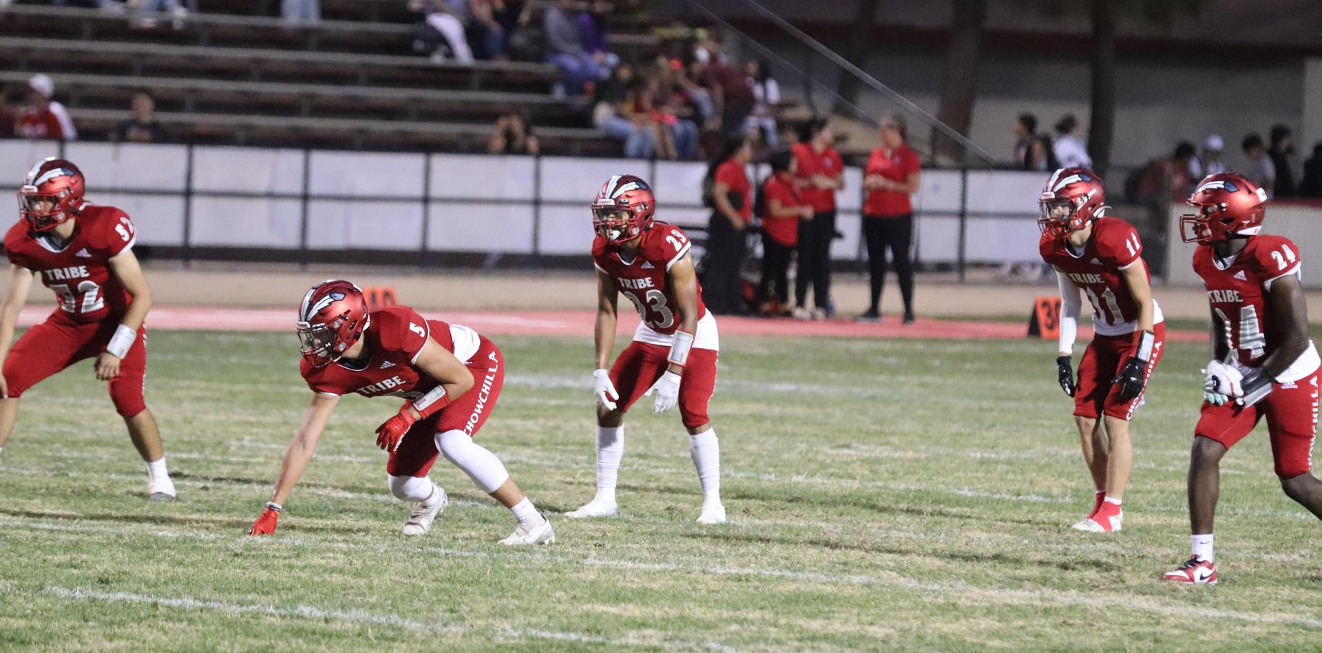 varsity football players in action against Riverdale
