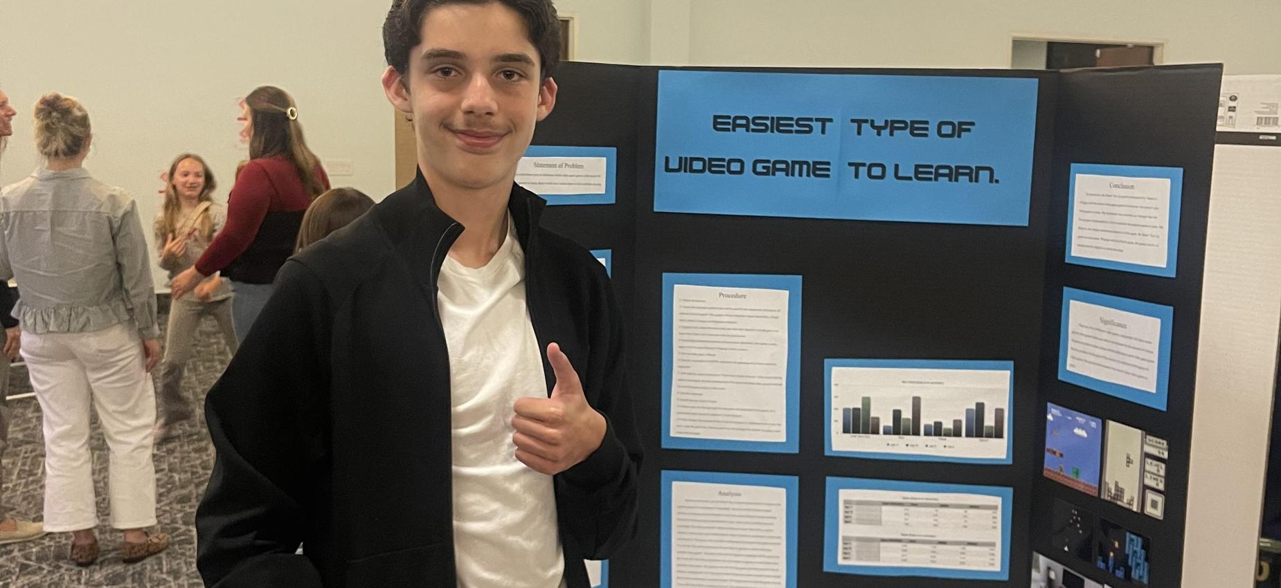 7th grade student posing in front of Science experiment