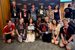 group of students holding a certificate in front of AHSTF backdrop