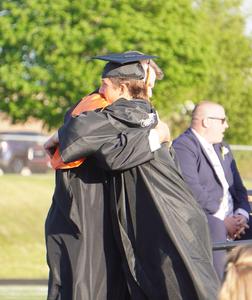 A graduate hugs the assistant principal.