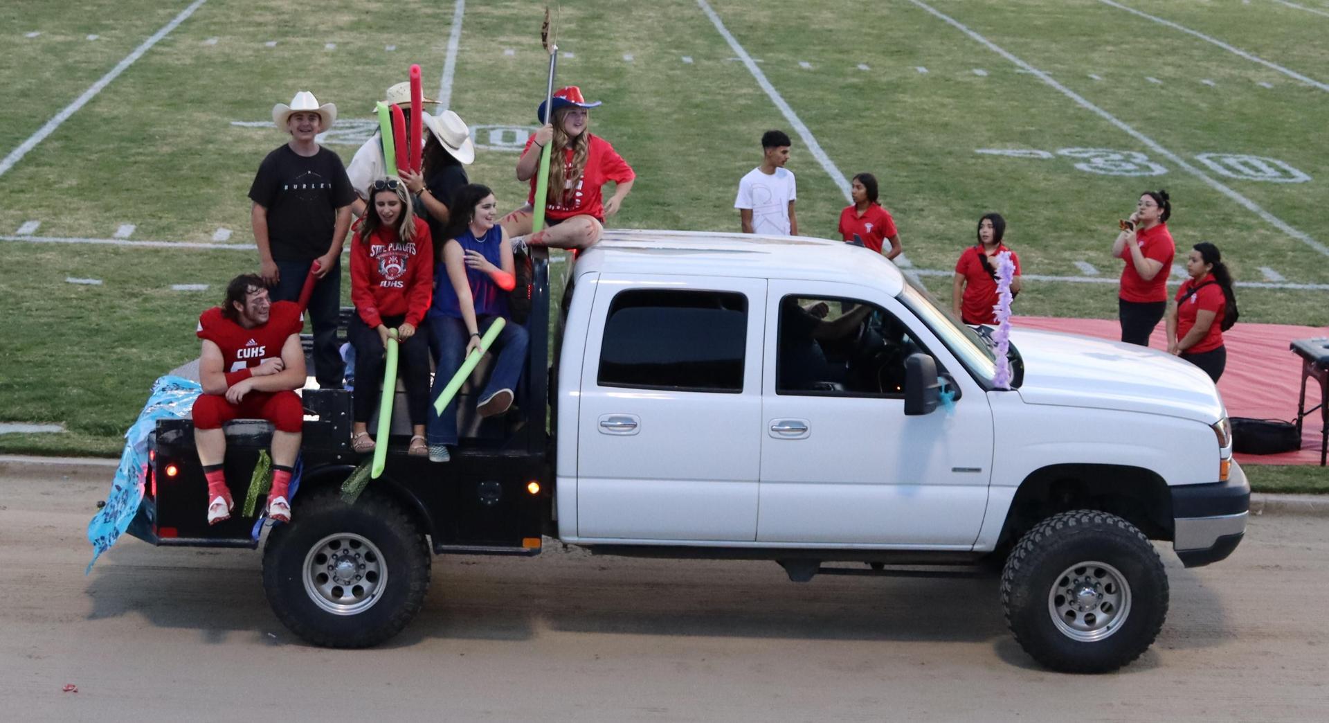 students, staff, and community members enjoying Friday night at the football game