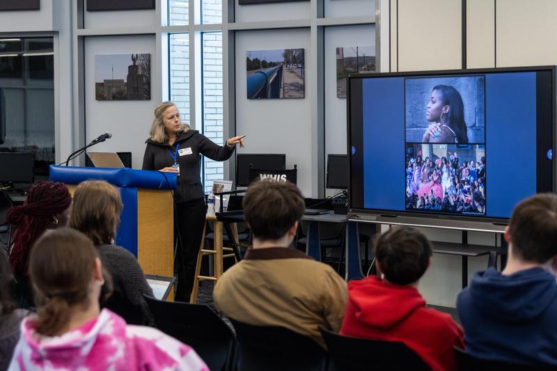 Martha Rial gestures to a photo during her talk