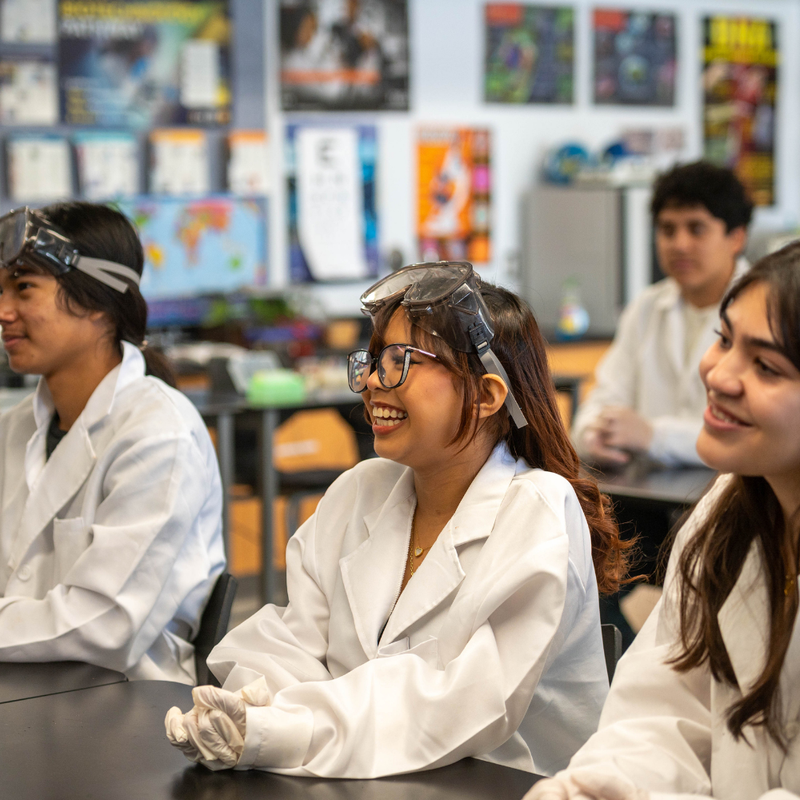 Students in a science class with lab coats