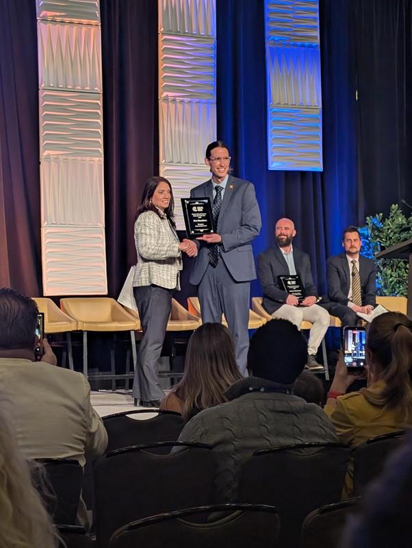 Ms. Hamilton receiving award from Colorado League of Charter School member