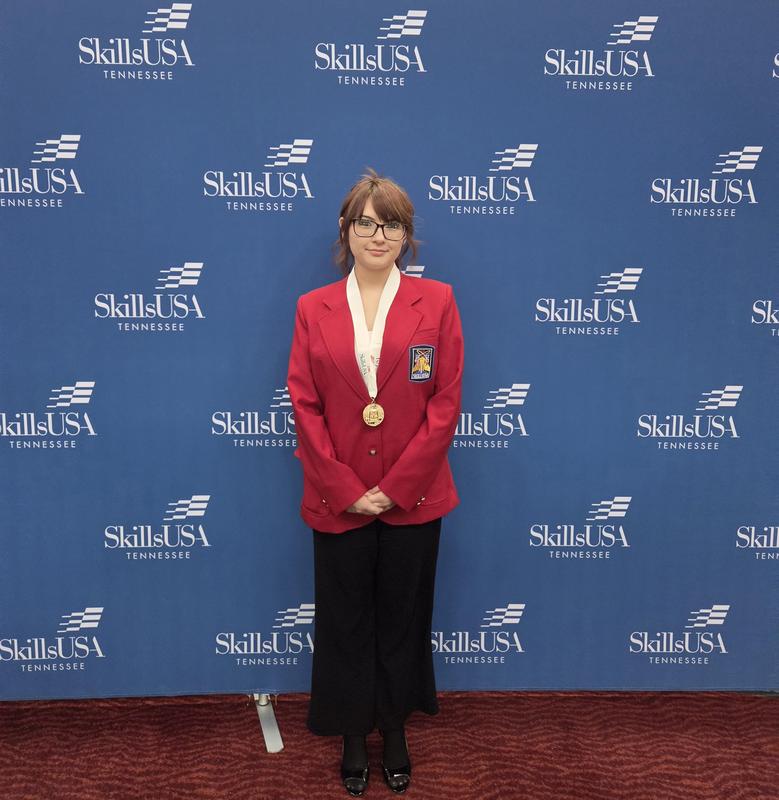 Smiling students with awards