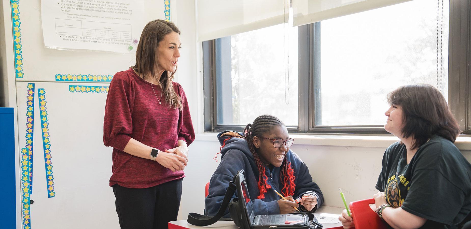 teacher speaking with students