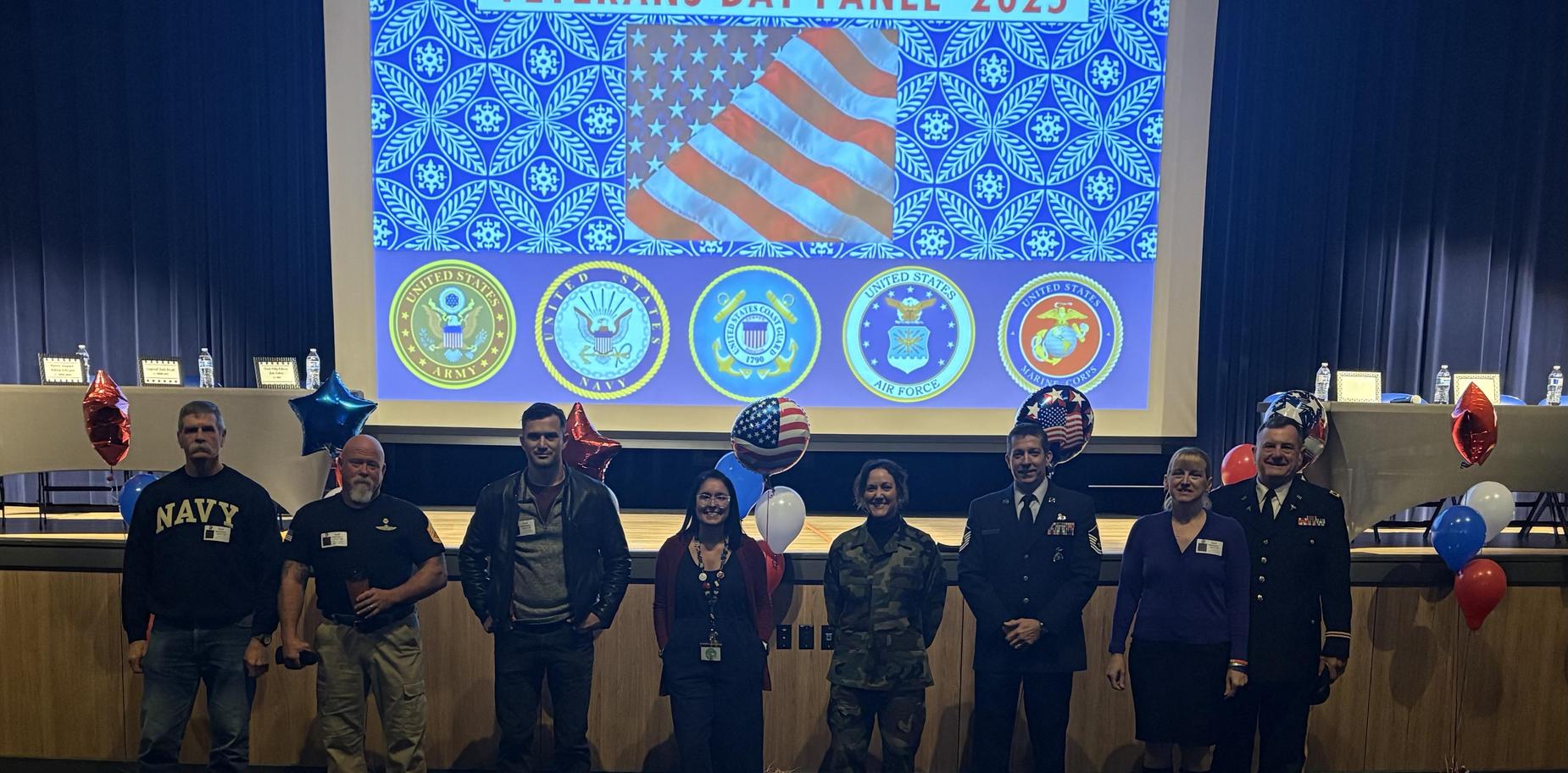 Veterans and service members standing together at an event, celebrating a patriotic theme.
