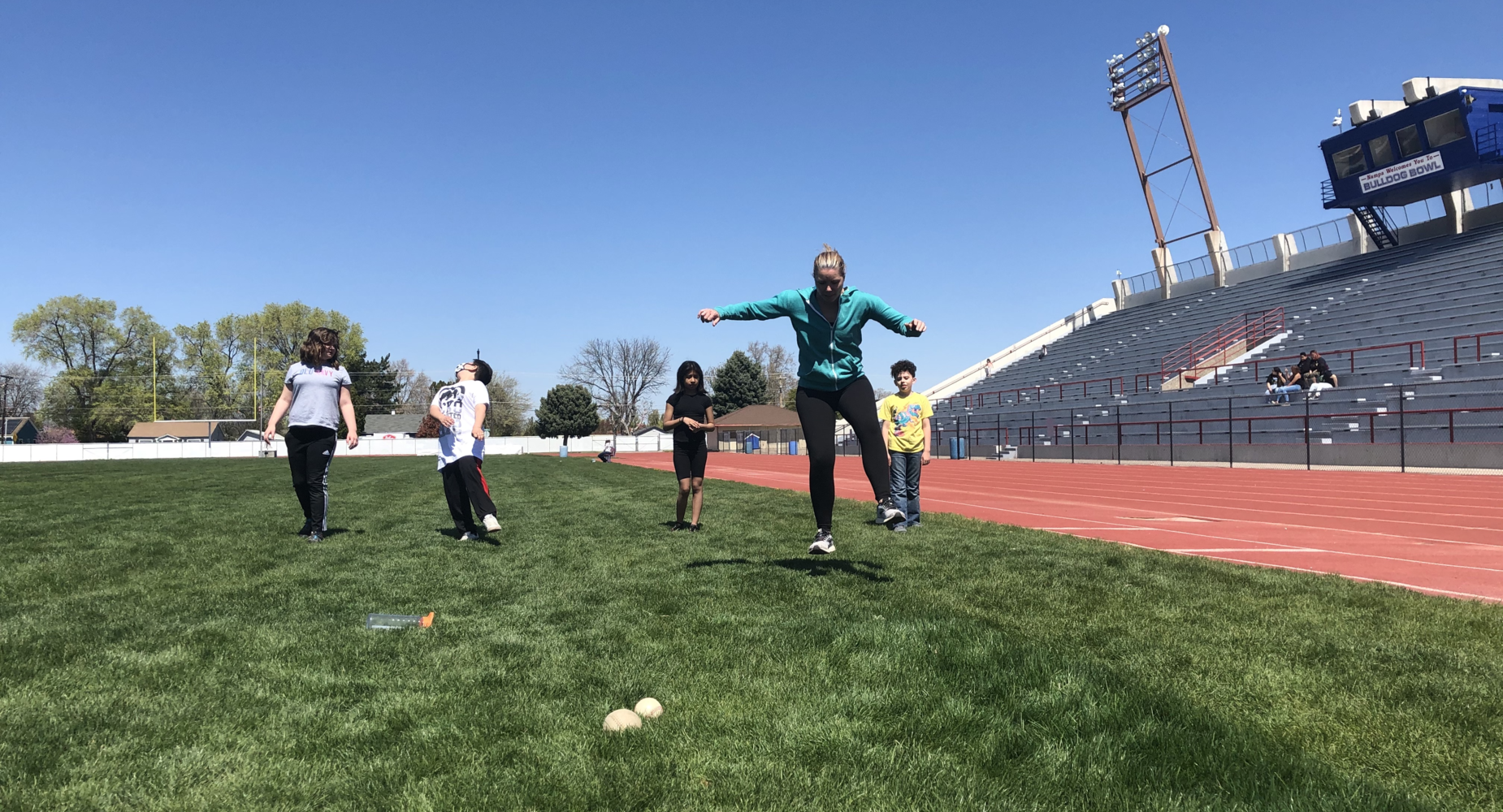 Coach Higgins practicing for the track meet with fifth-grade students.