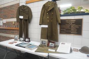 Old Army clothing and photos are displayed.