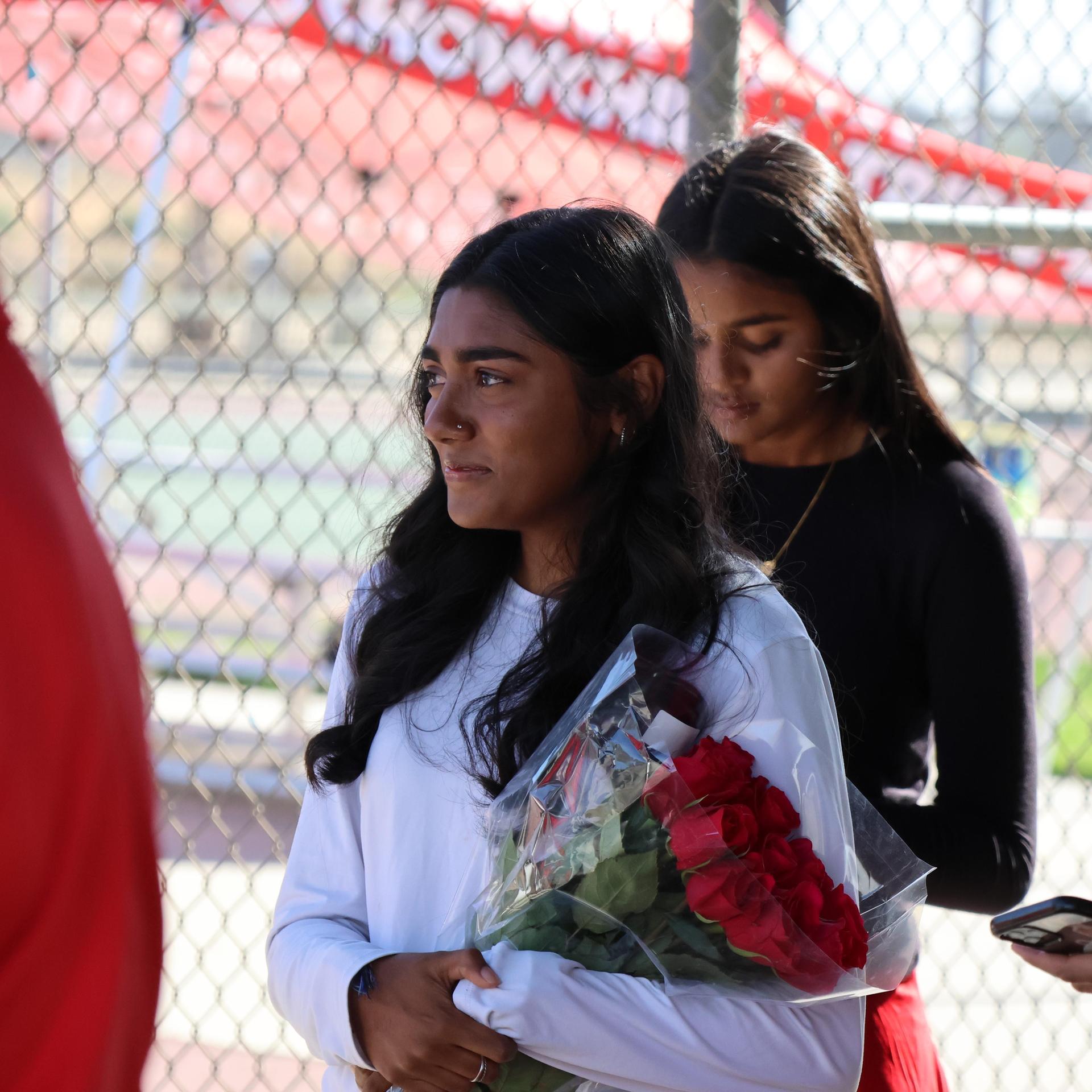 tennis players, family, and staff celebrating senior night