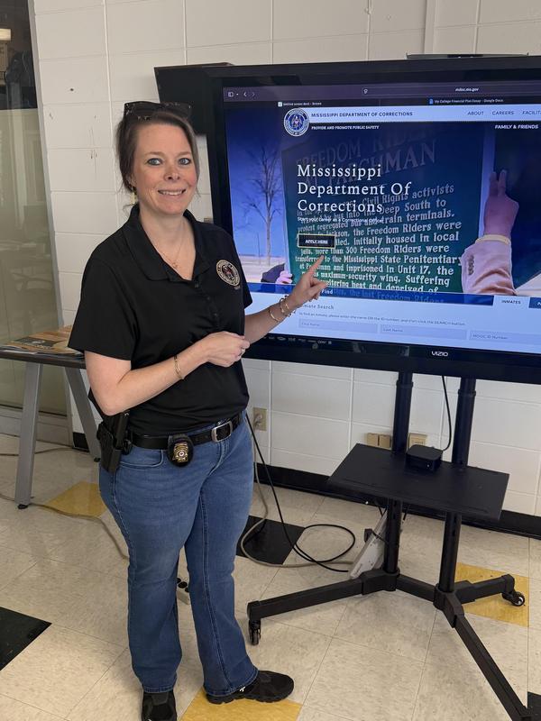 Elizabeth McClendon - MDOC, standing in front of tv in CCR room