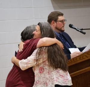 Landscpaing instructor hugs student