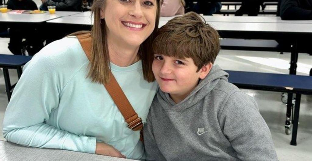 Mother and son smiling at Donuts with the Principal