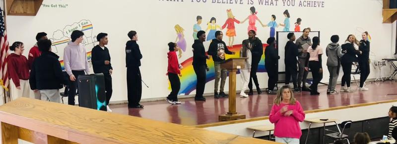 BHS students on stage with Davis students at lunch