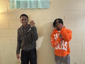 Students showing off their glow in the dark bracelets