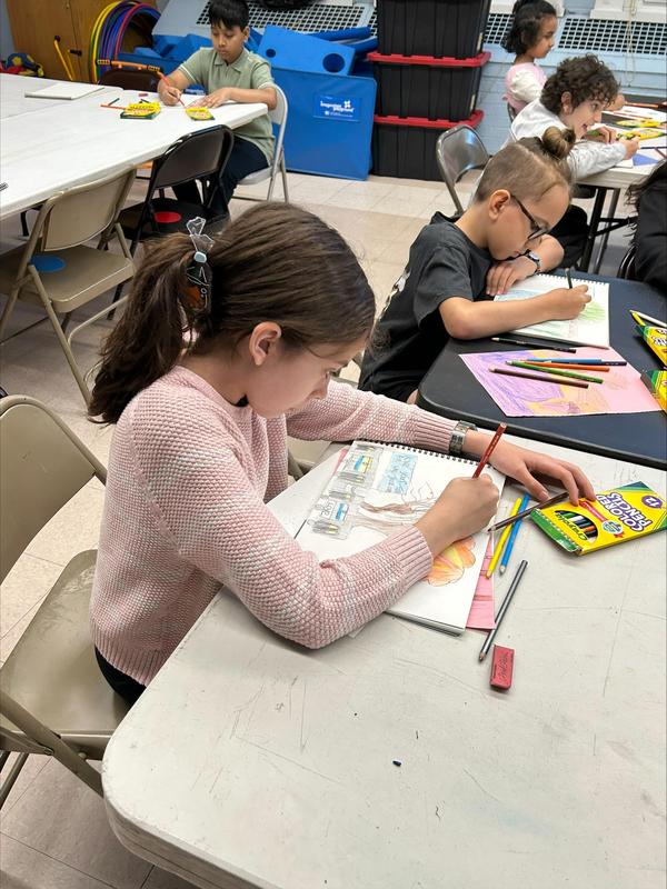 student sitting and drawing