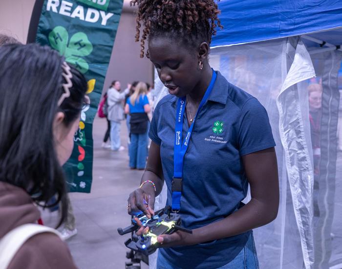 student instructing another student on using a drone
