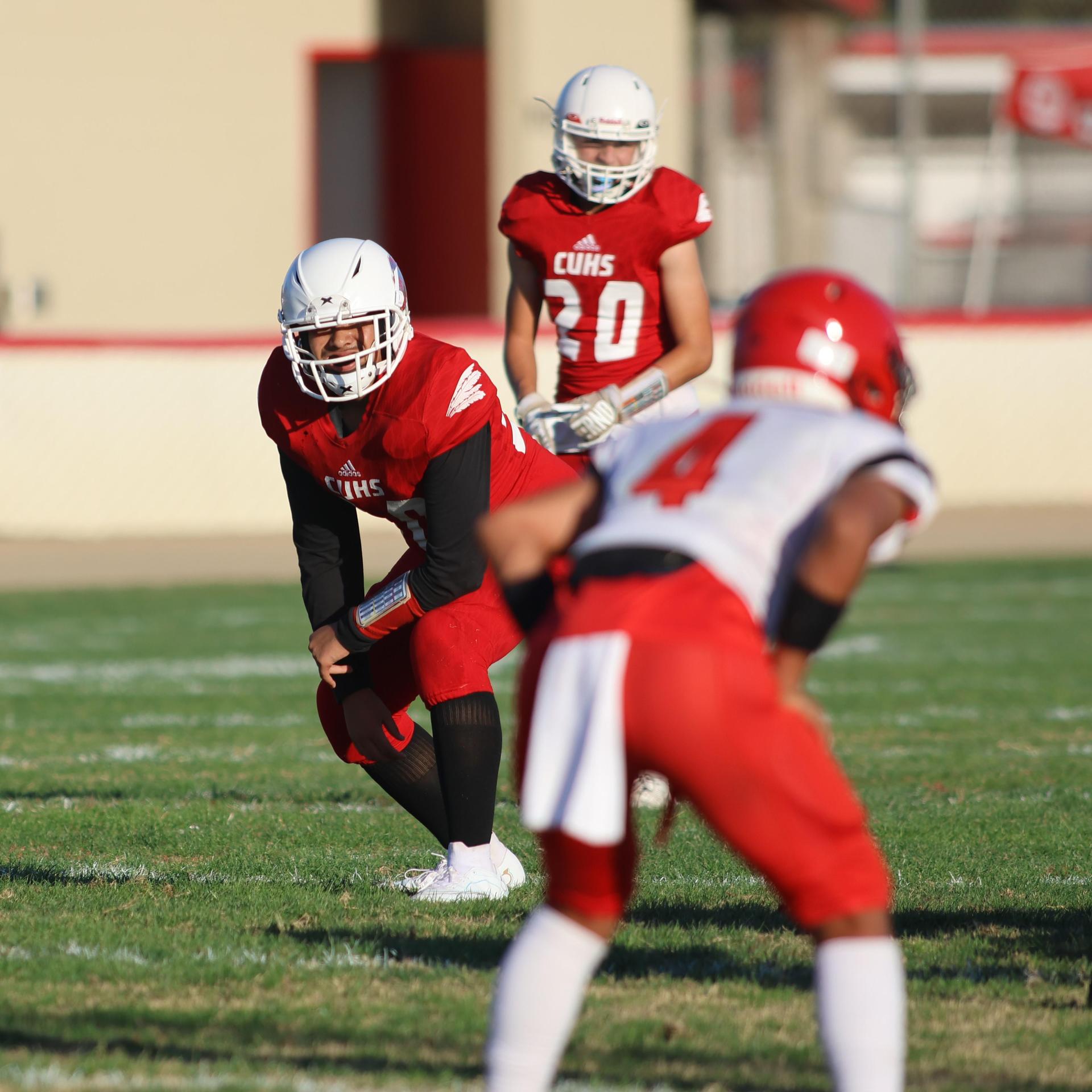 junior varsity football players in action against Fowler