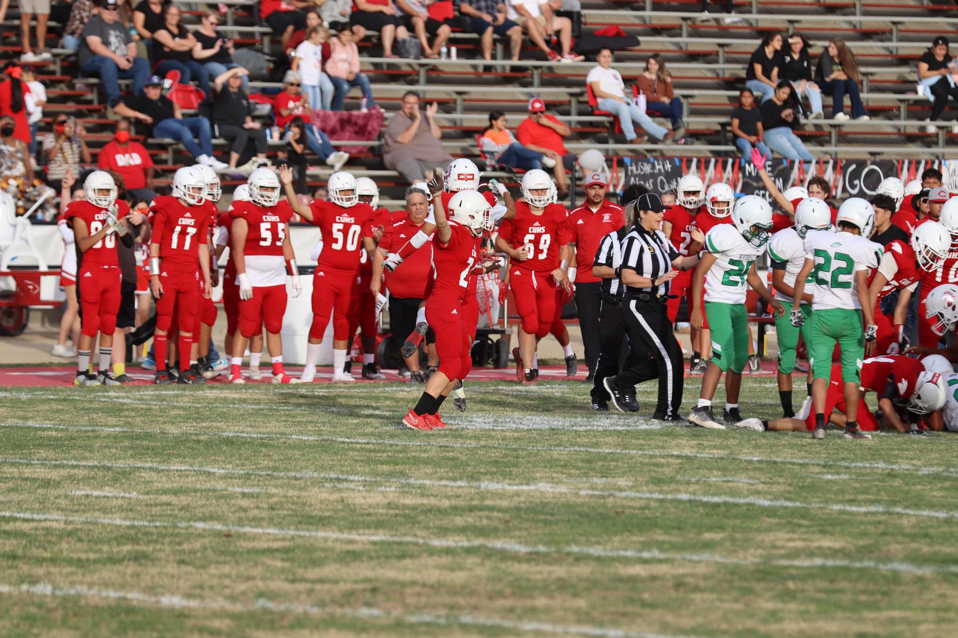  junior varsity football players in action against riverdale