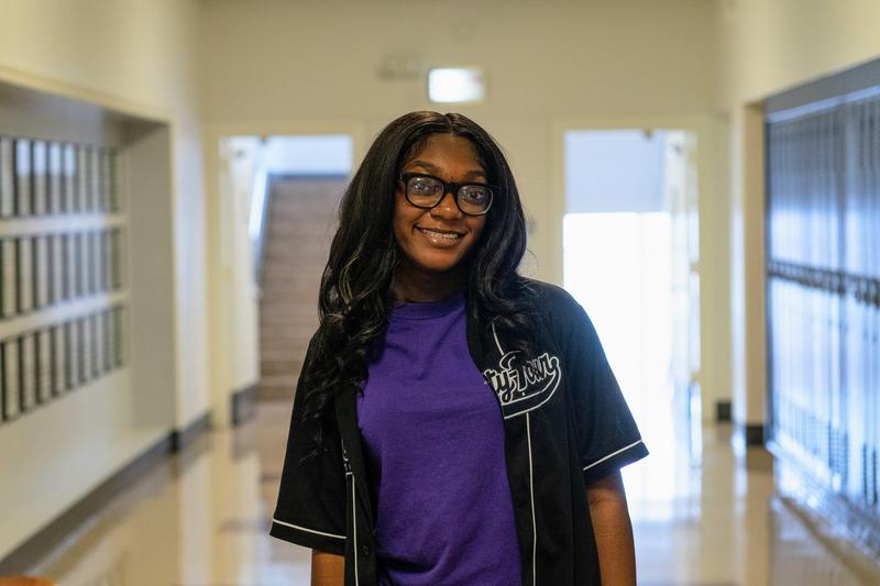 Student posing in hallway