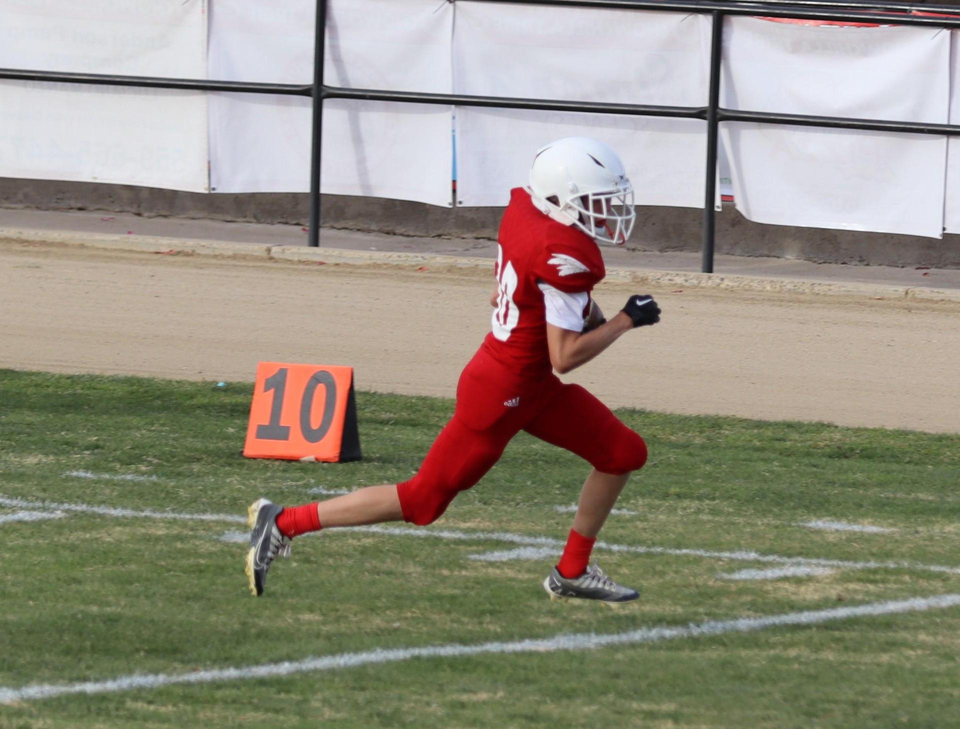  junior varsity football players in action against riverdale