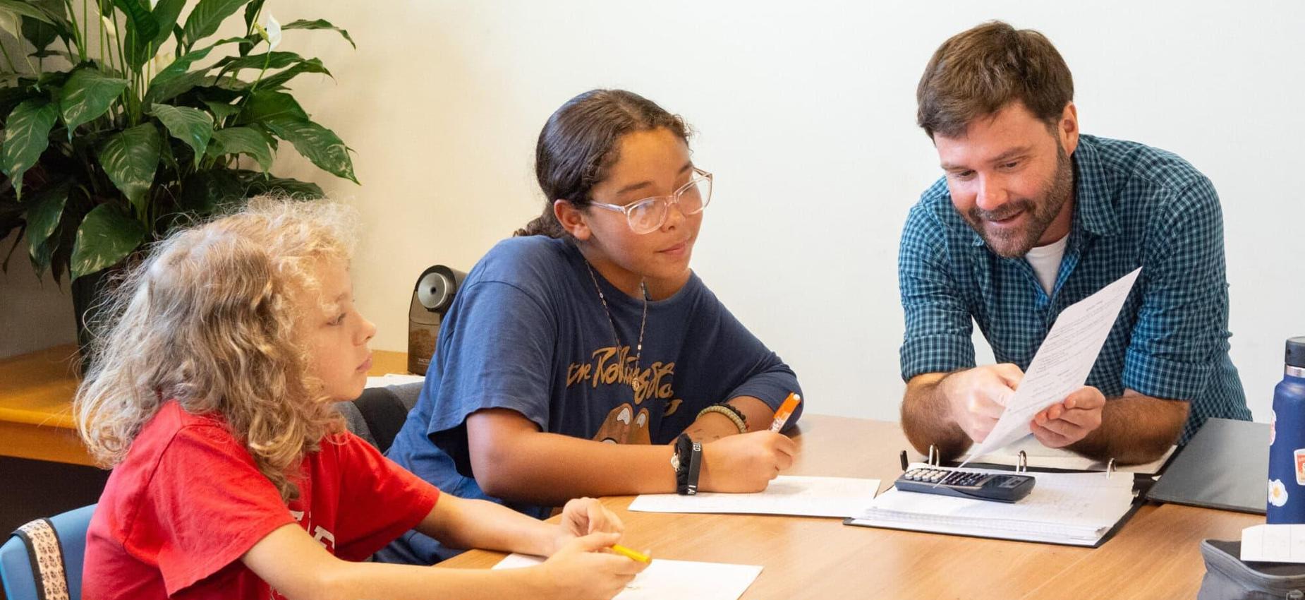 Middle school students being instructed by a math teacher