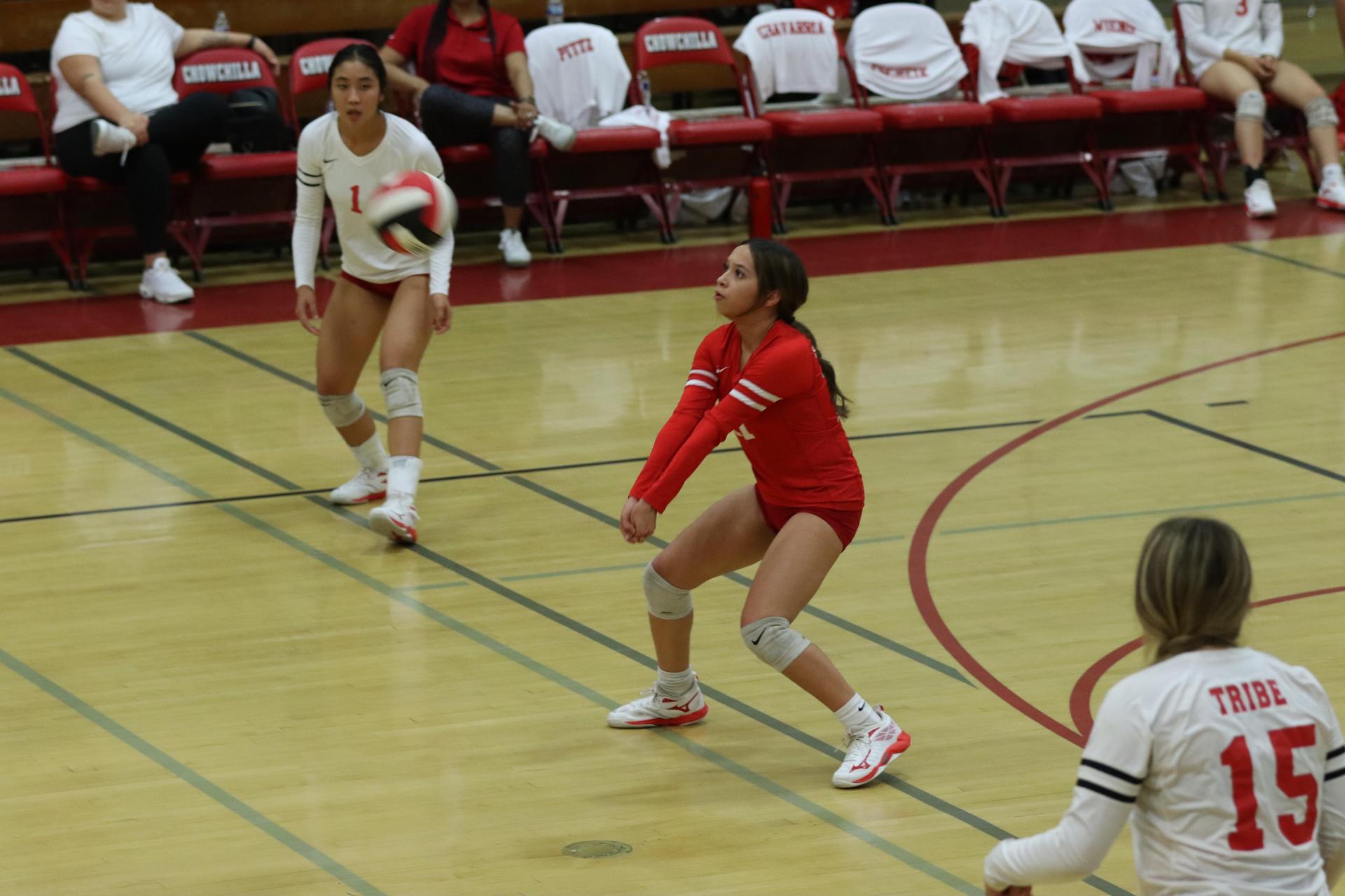 varsity volleyball players in action against liberty