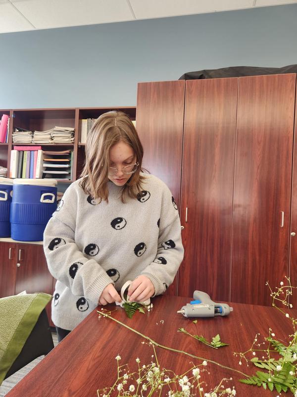 Leanna LeBathe constructing a corsage for an online contest.
