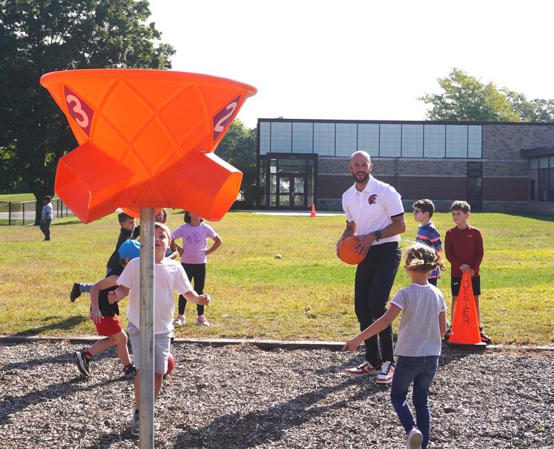 Mr. Sleeman joins in a game of funnel ball with McFall students.