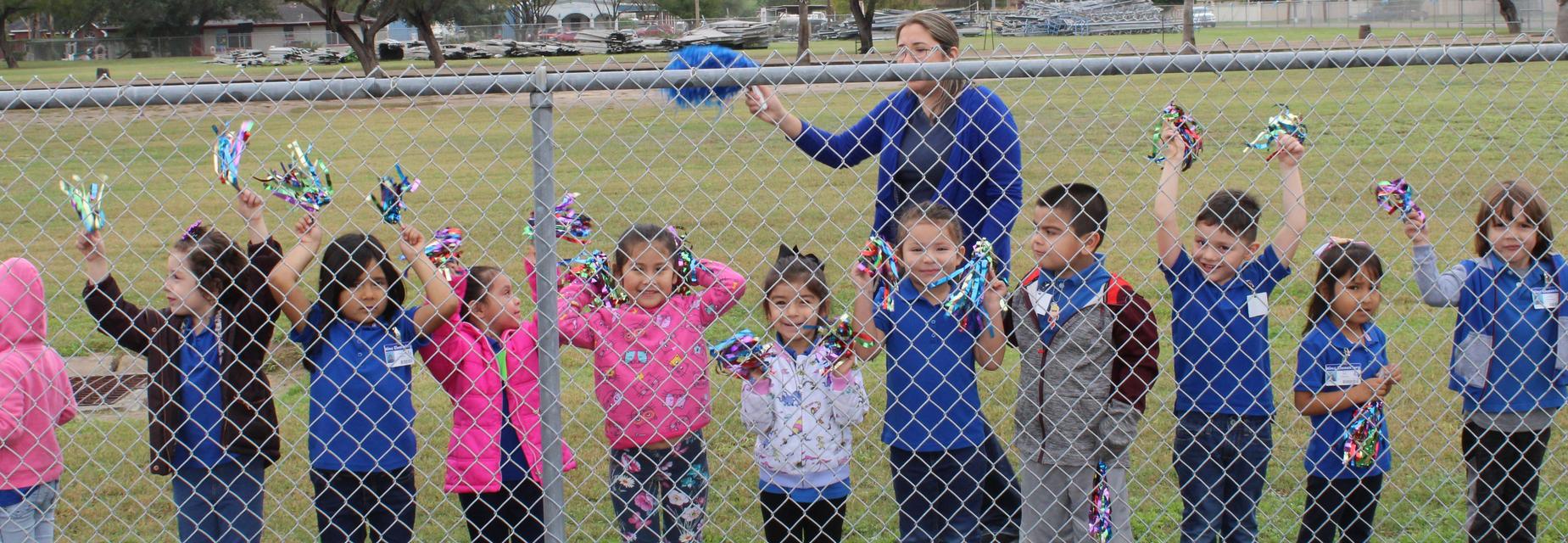 teacher and students with pompoms