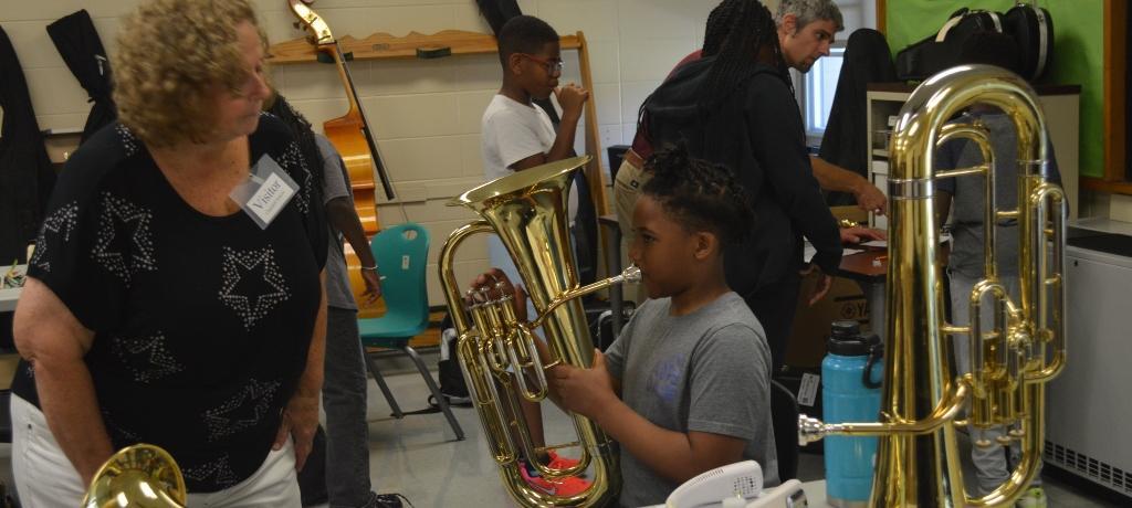 boy blows into an euphonium