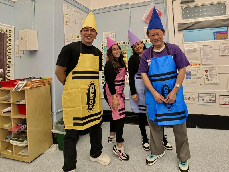 4 adults dressed as crayons