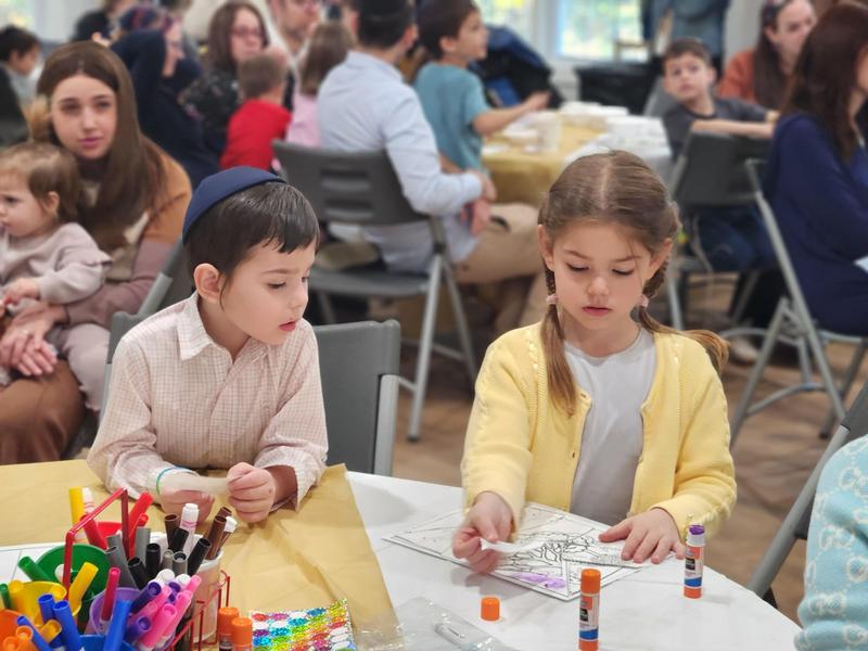 Two siblings at the puzzle table