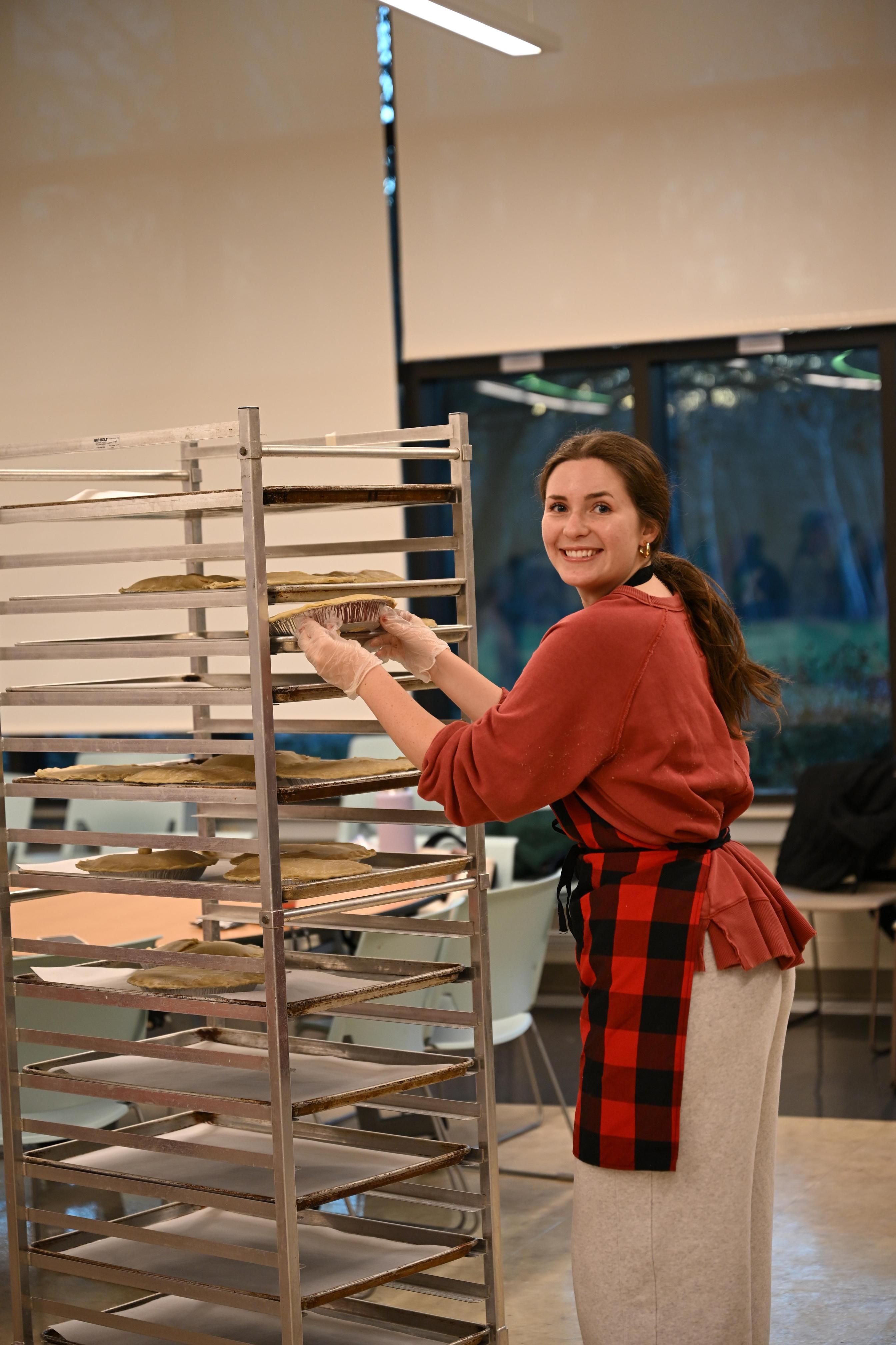 A Student Places A Pie During A Mercy Service Project