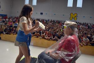 a student throwing a pie in a teacher's face