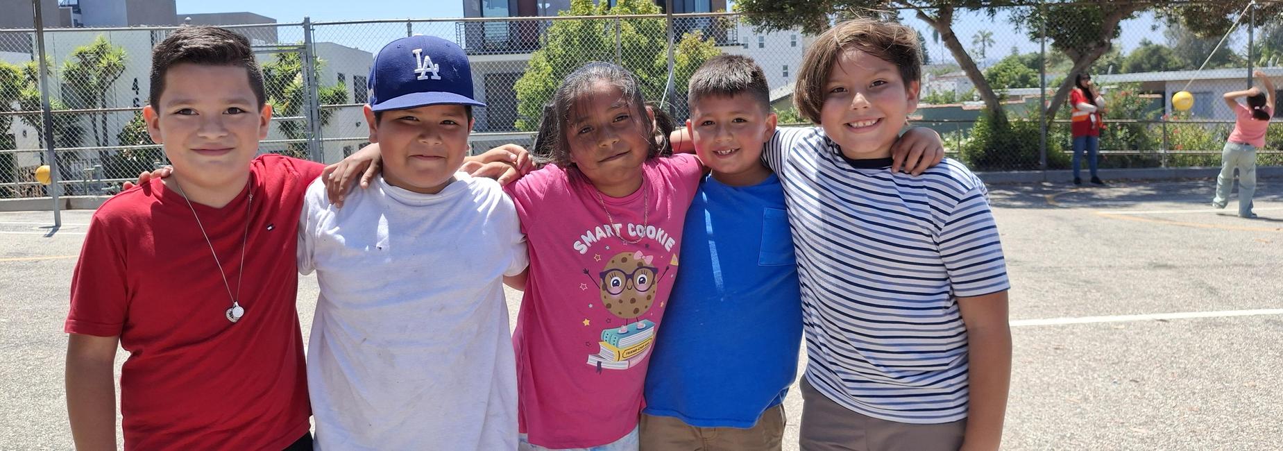 A group of five students smile for the camera.