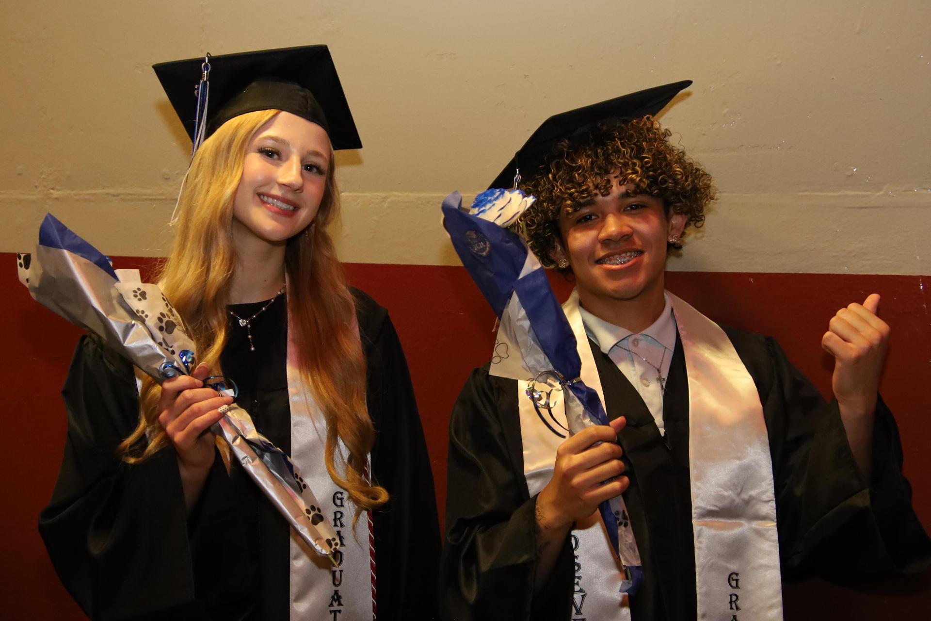Students smiling at graduation ceremony