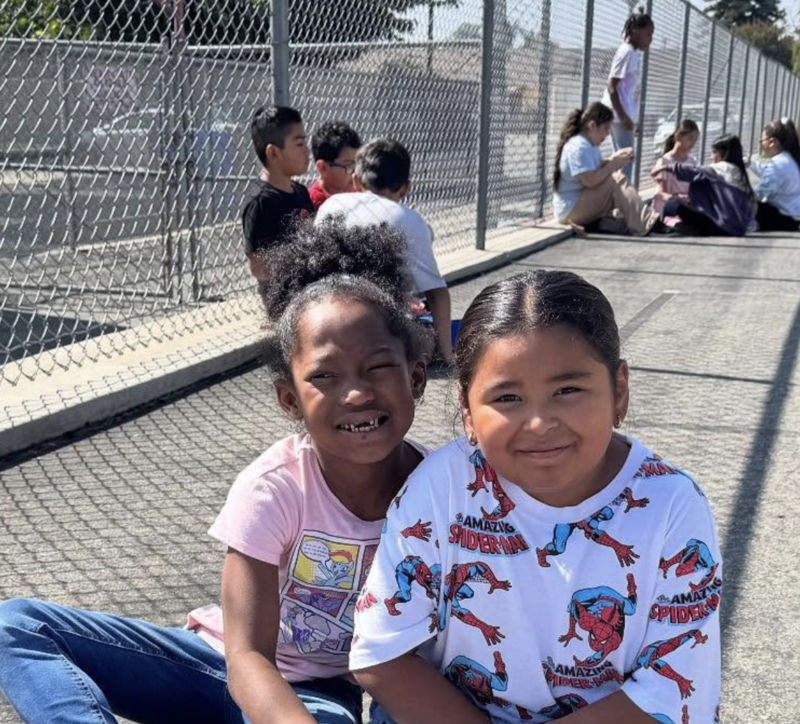 Two students are wearing matching superhero shirts in support of attendance