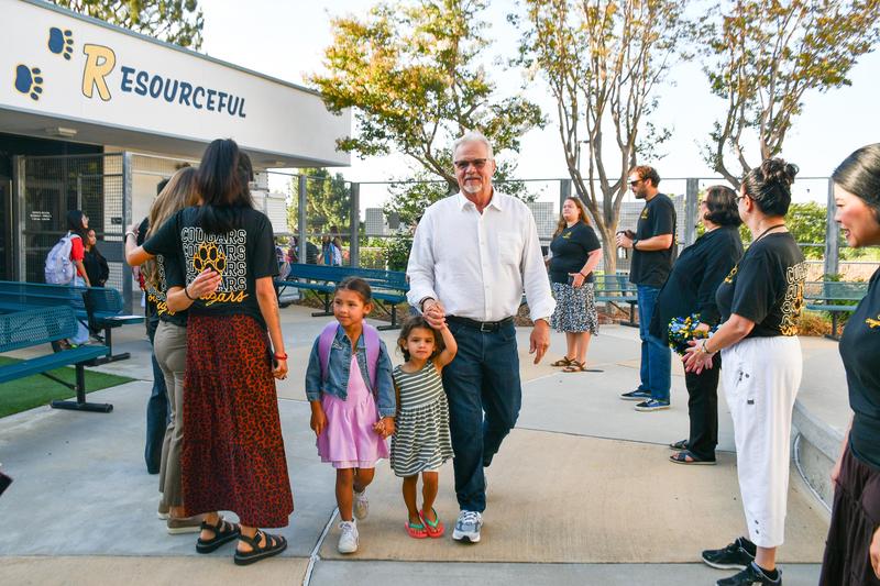 Collegewood staff line the entrance to cheer as students arrive on the first day of school.